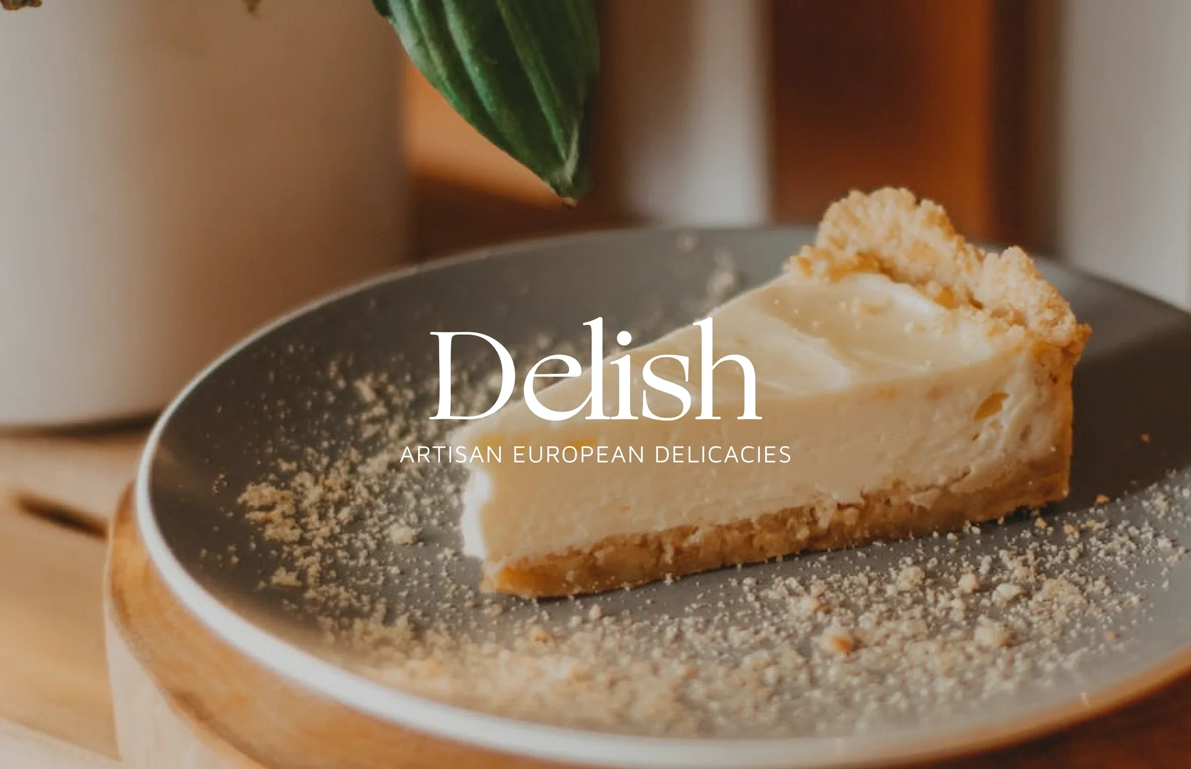 Delish cheesecake studio logo on a photo of cheesecake